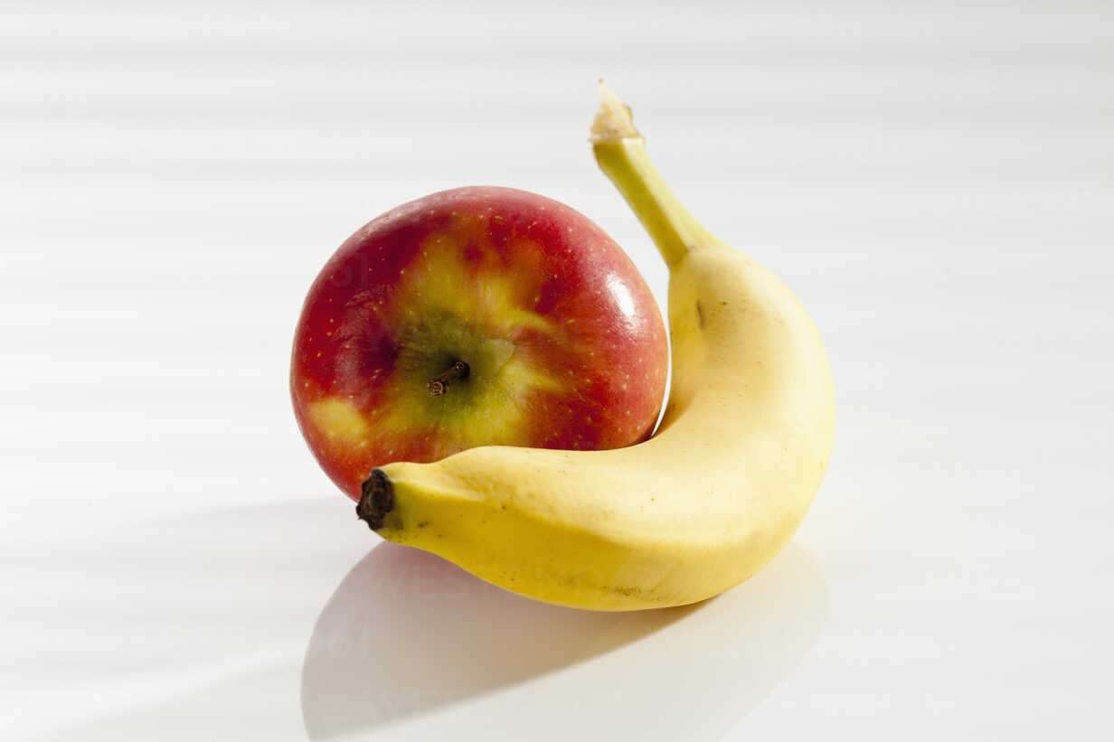 banana-with-apple-on-white-background-close-up-csf017515